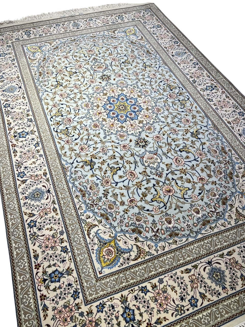 Persian rug featuring a central medallion design and elegant floral motifs.